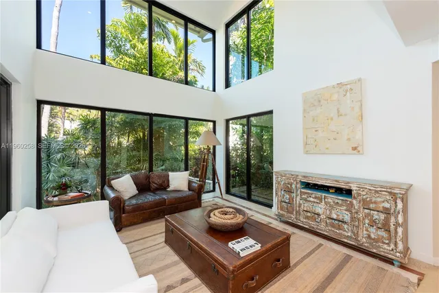 a living room with furniture and large windows