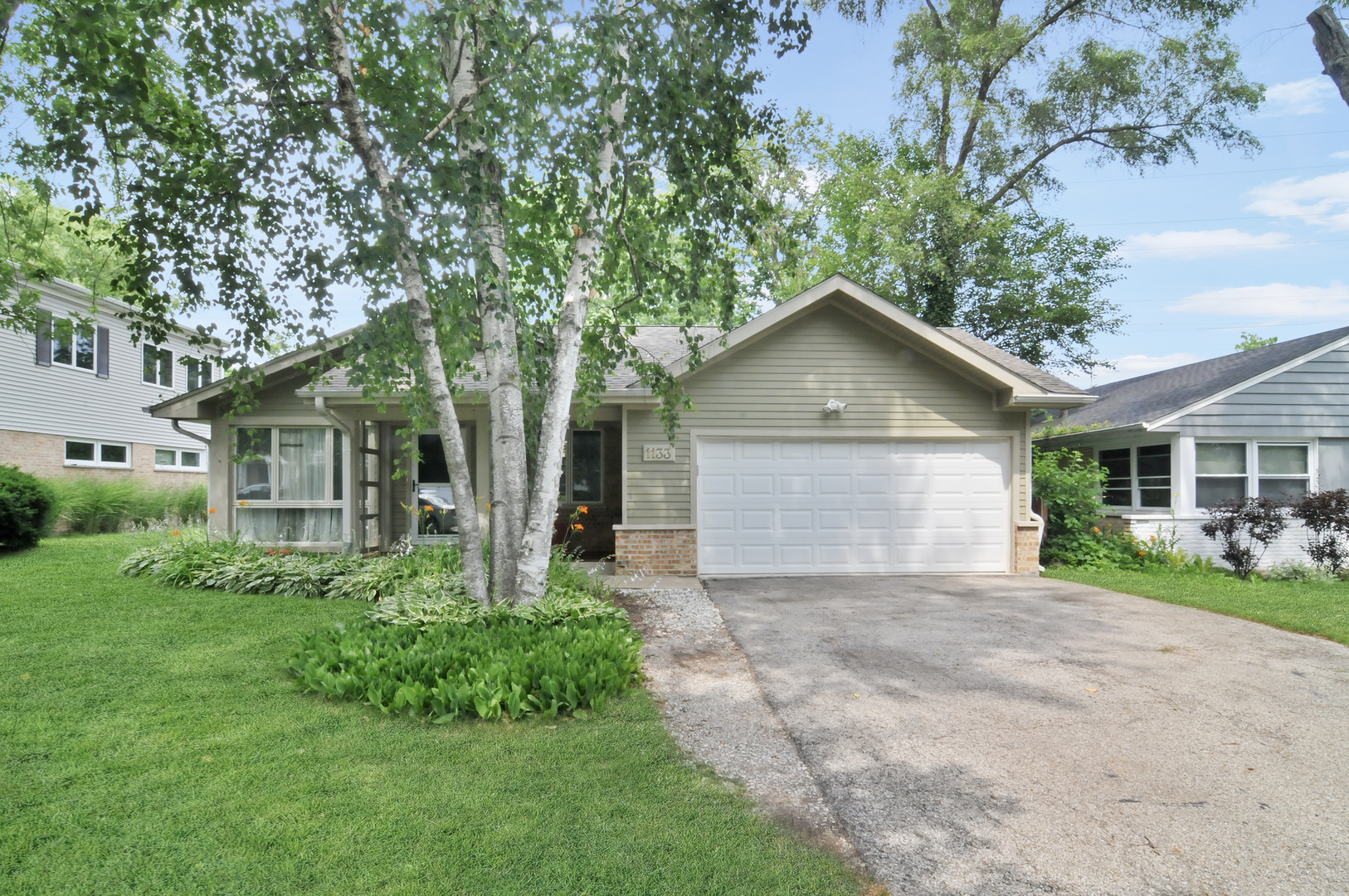 1133 Dell Road Northbrook, IL 60062 - Photo 1 of 6 a front view of house with yard and green space