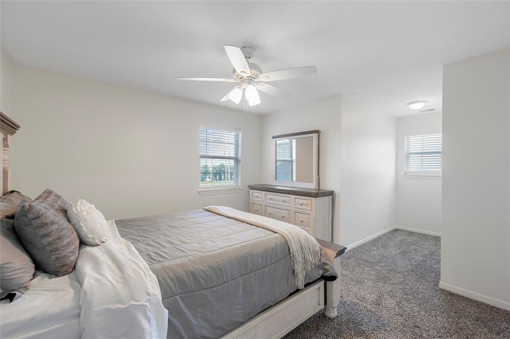 5112 Old Caufield Ranch Road McGregor, TX 76657 - Photo 25 of 38 Bedroom with carpet floors and ceiling fan