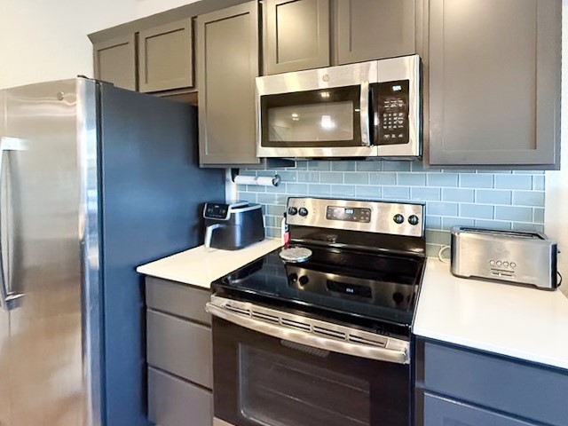 1805 Roseburg Drive, Unit 31 Austin, TX 78754 - Photo 5 of 19 a kitchen with a stove and a microwave