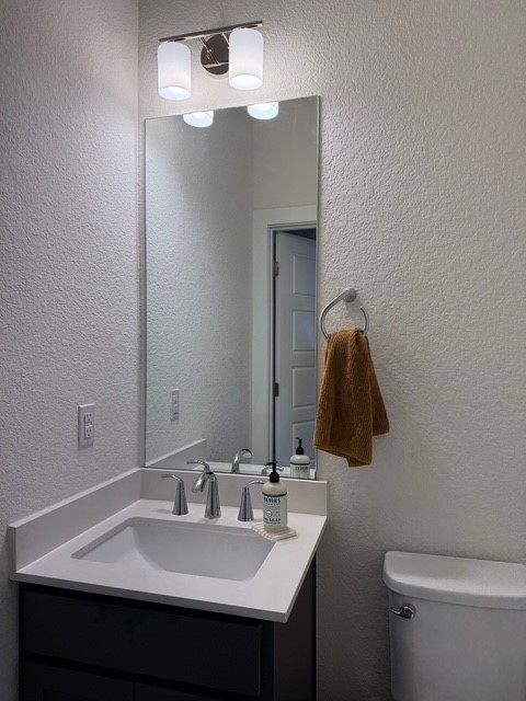 1805 Roseburg Drive, Unit 31 Austin, TX 78754 - Photo 6 of 19 a bathroom with a sink vanity and a toilet