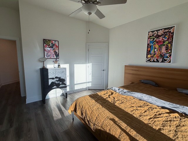 1805 Roseburg Drive, Unit 31 Austin, TX 78754 - Photo 8 of 19 a bedroom with a bed and wooden floor
