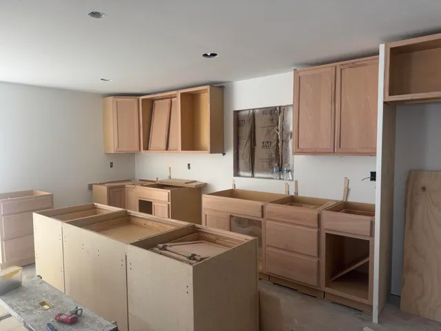 a utility room with cabinets washer and dryer
