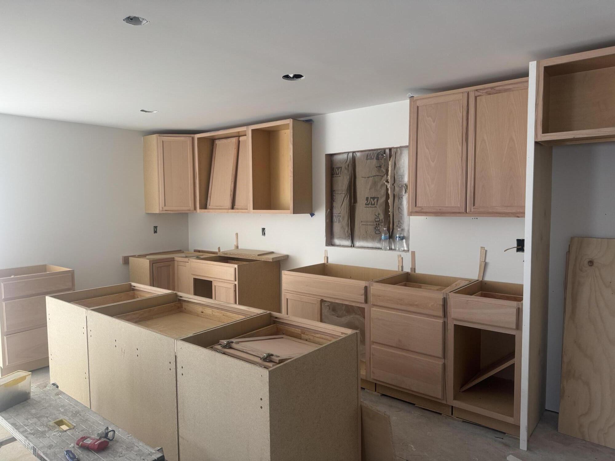 608 Essen Street Brook, IN 47922 - Photo 2 of 7 a utility room with cabinets washer and dryer