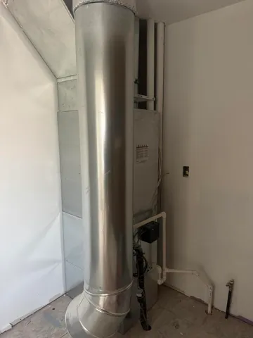 a room with water heater and storage
