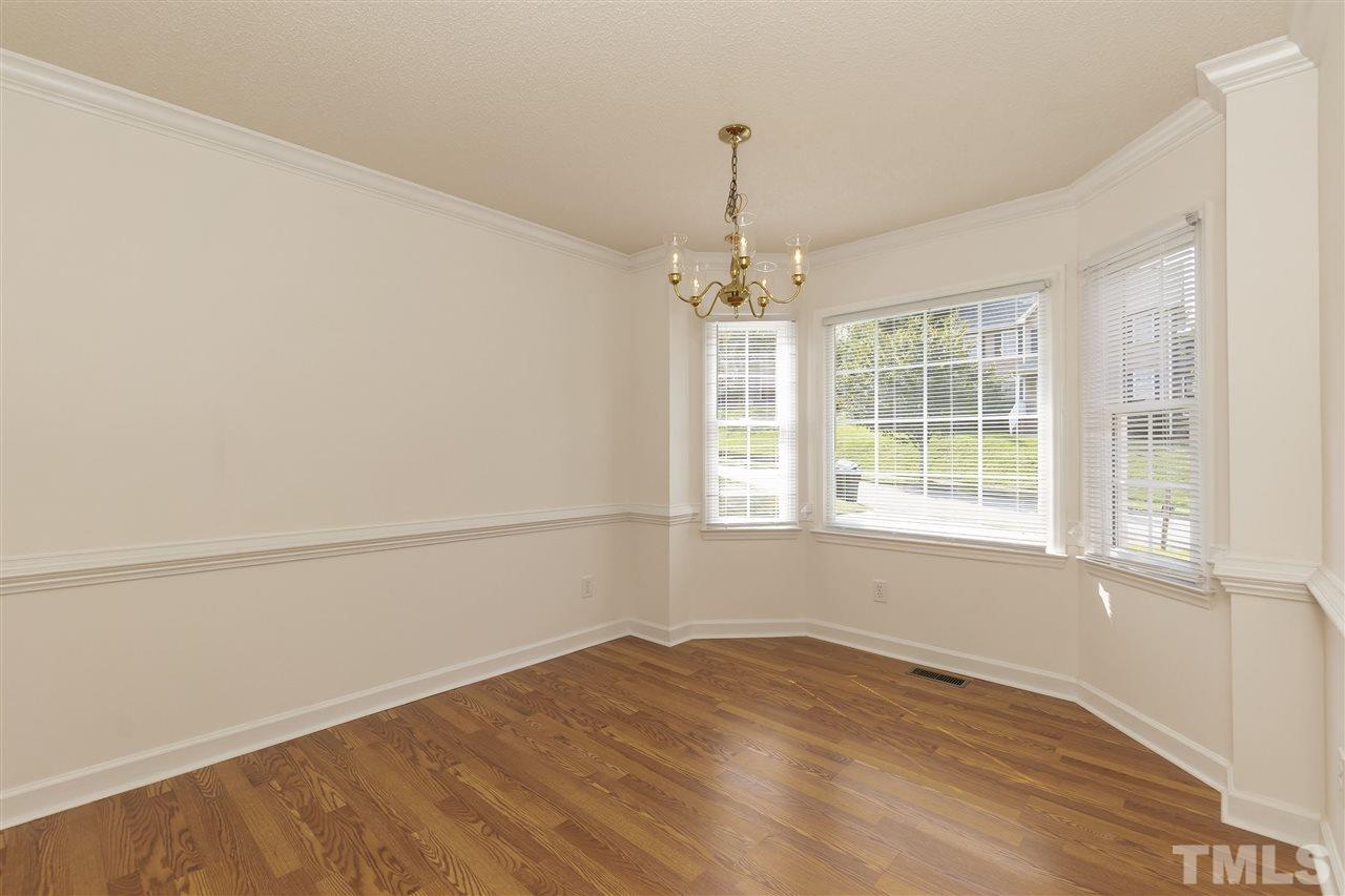 4301 Willow Lake Road Raleigh, NC 27616 - Photo 6 of 30 an empty room with wooden floor fan and windows