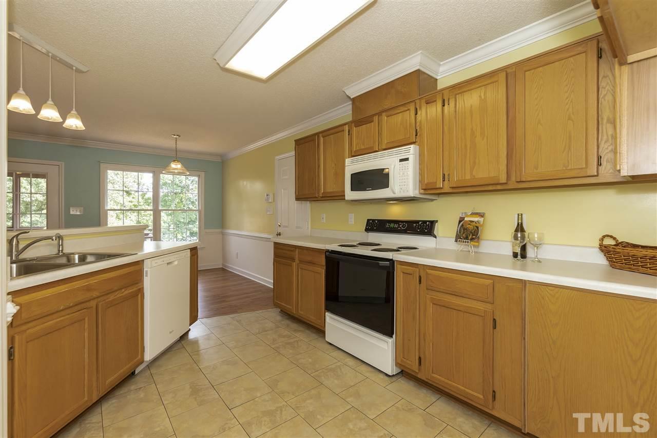 4301 Willow Lake Road Raleigh, NC 27616 - Photo 8 of 30 a kitchen with stainless steel appliances granite countertop a sink and stove top oven