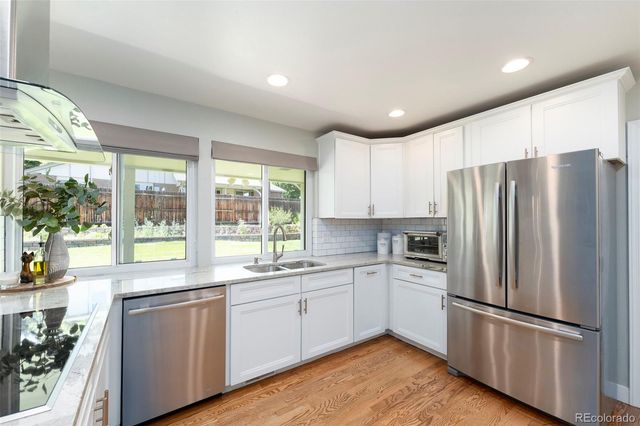 a kitchen with a refrigerator a sink and cabinets