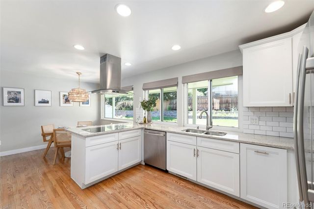 a kitchen with a sink windows and cabinets