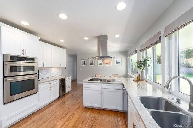 a kitchen with a stove a sink and a microwave