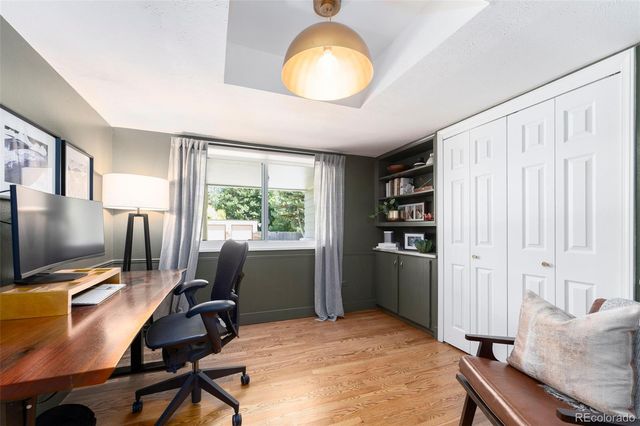 a view of a workspace with furniture and a window