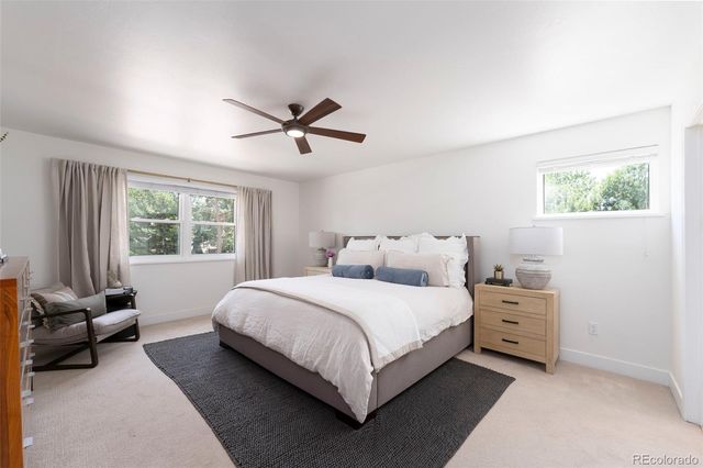 a bedroom with a bed a couch and a window