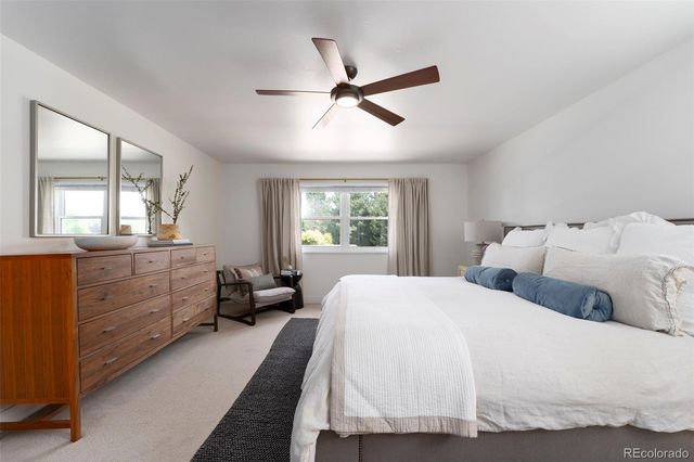 a spacious bedroom with a bed and a window