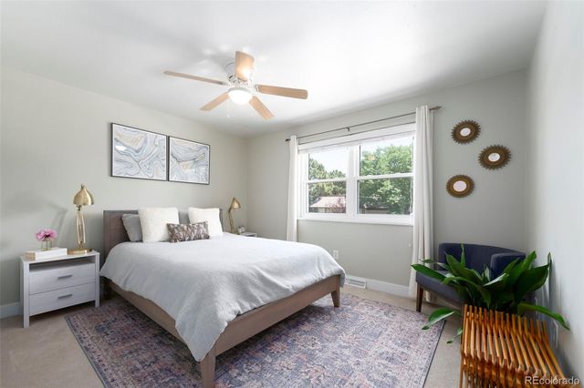 a bathroom with a granite countertop sink mirror and a window