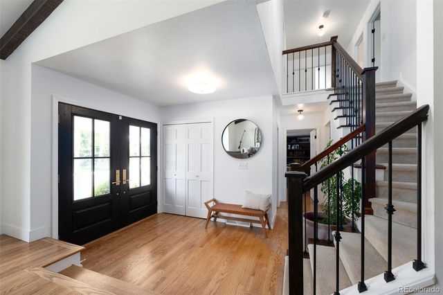 a view of a room with lots of wooden floor and windows