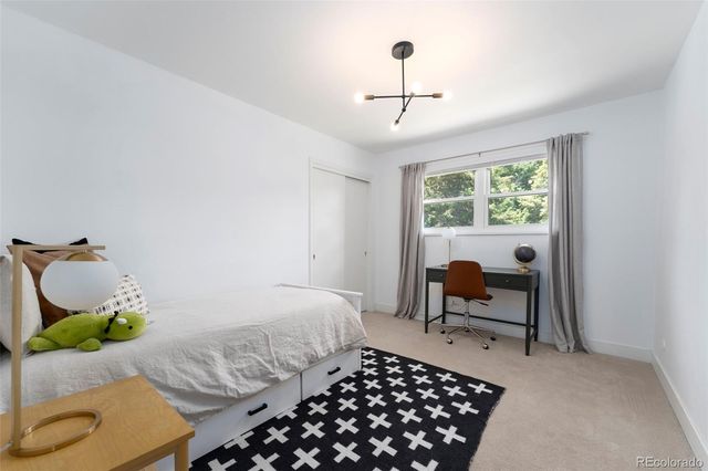 a bedroom with a bed and a chandelier