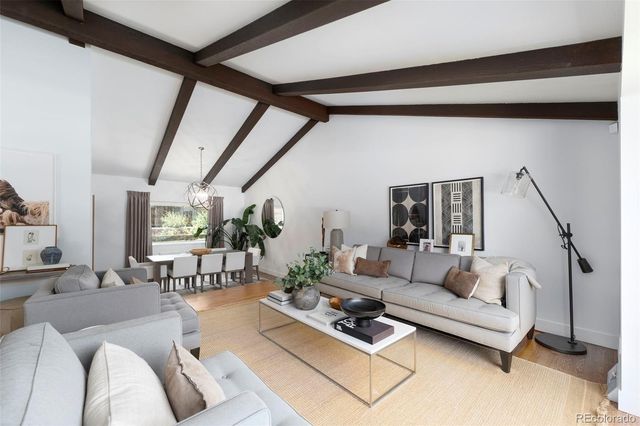 a living room with furniture a rug and a table