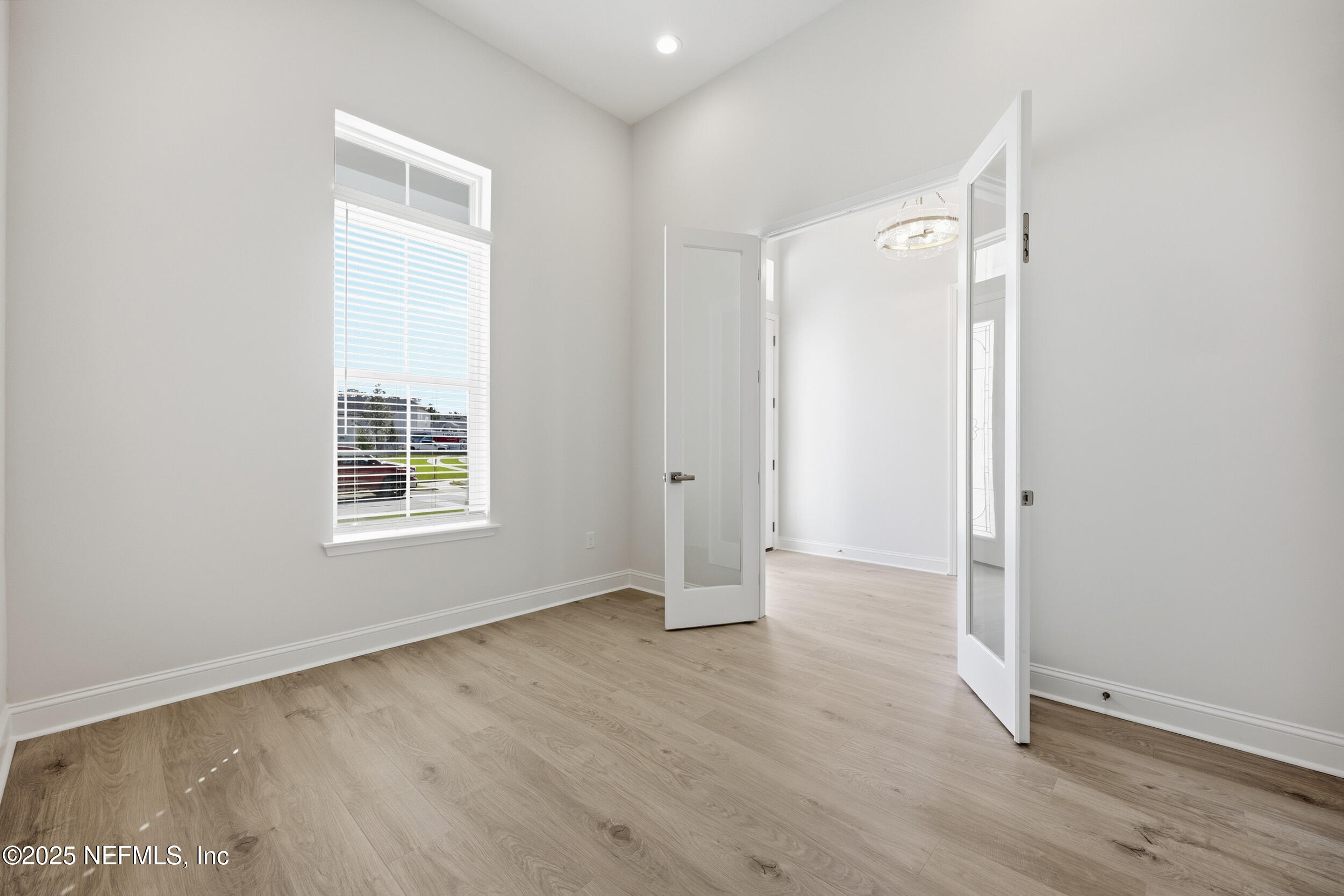23 Owl Lndg Way St. Augustine, FL 32092 - Photo 17 of 19 an empty room with wooden floor and windows