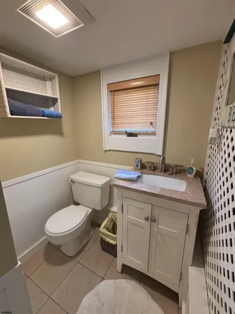 a kitchen with a dining table chairs and a refrigerator