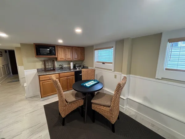 a living room with furniture a rug and a flat screen tv