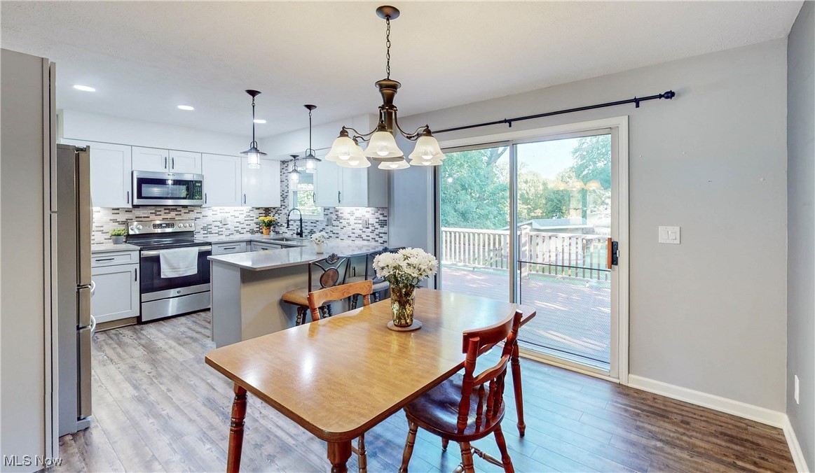 3491 Kent Road Stow, OH 44224 - Photo 13 of 40 Dining room with hanging light fixture and patio door to backyard