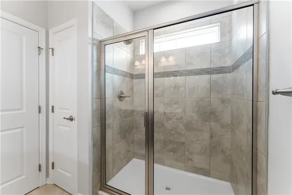 a bathroom with a glass shower door
