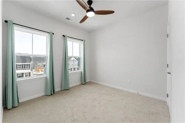 an empty room with windows and closet