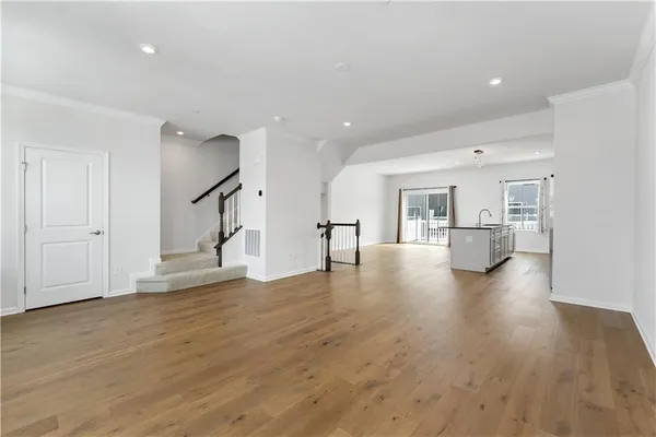 a view of a kitchen with furniture and wooden floor