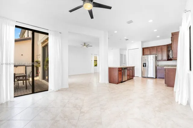 a view of a kitchen with a sink and stainless steel appliances