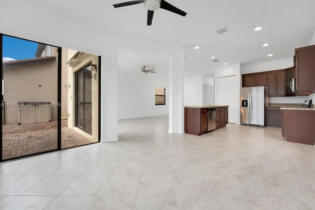 a view of a kitchen with furniture and a ceiling fan