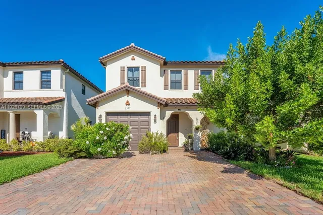 a front view of a house with a garden