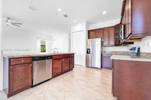 a bathroom with a granite countertop sink toilet and bathtub