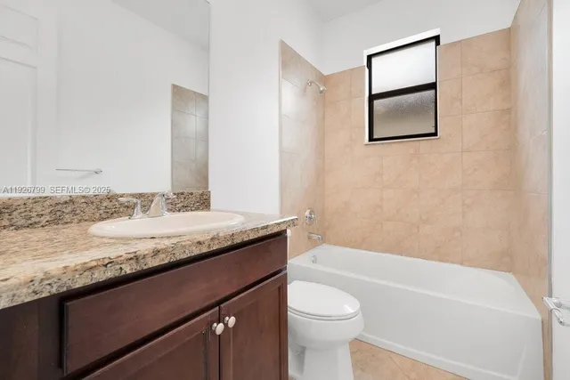 a kitchen with stainless steel appliances granite countertop a refrigerator a sink and a stove