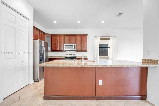 an empty room with wooden floor closet and ceiling fan