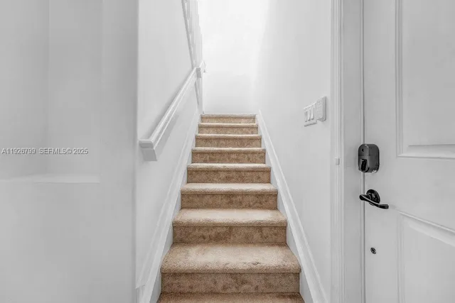 an empty room with a window and a ceiling fan
