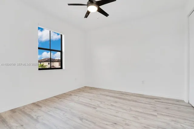 a view of a room with wooden floor
