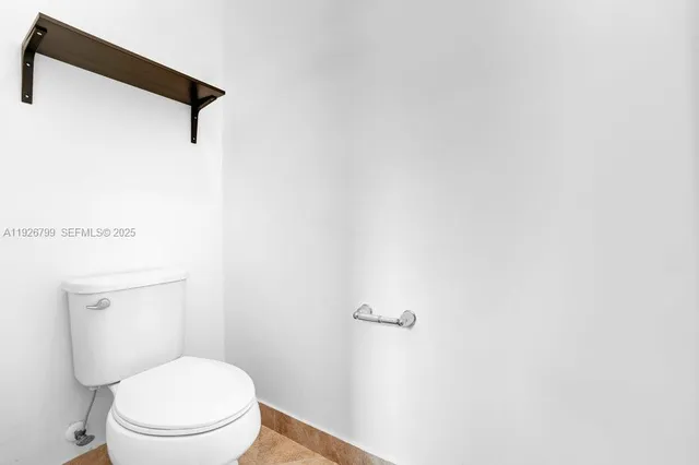 an empty room with fan and windows