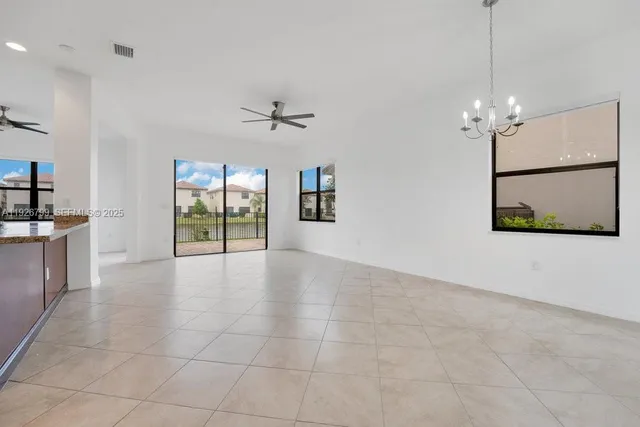 a view of a livingroom with furniture ceiling fan and window