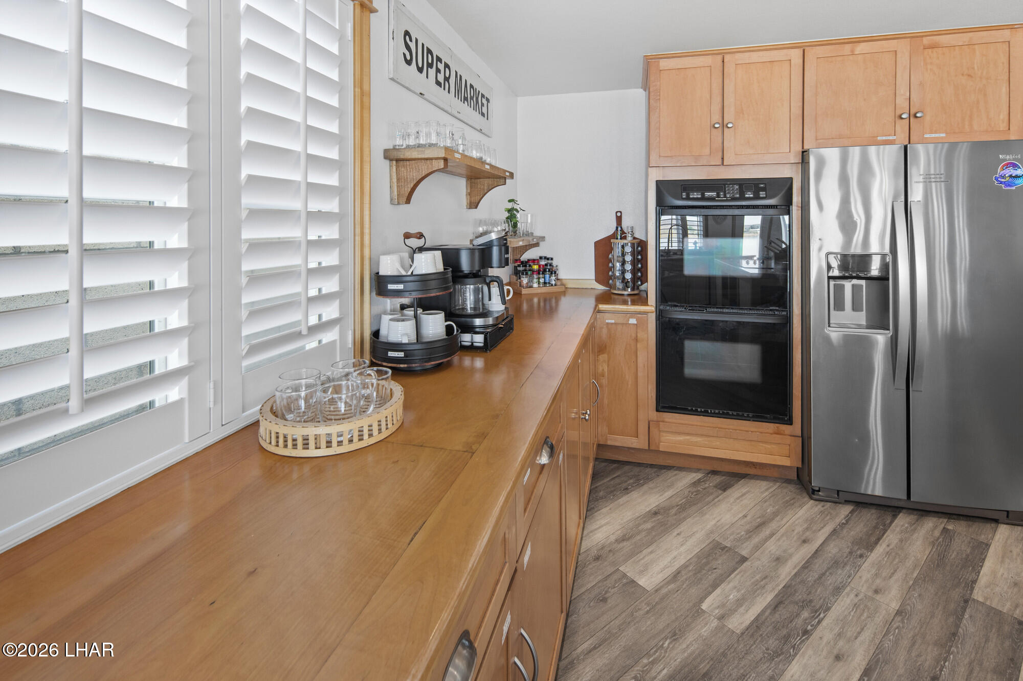 7870 Riverside Drive Parker, AZ 85344 - Photo 15 of 88 a kitchen with stainless steel appliances wooden floor and a refrigerator