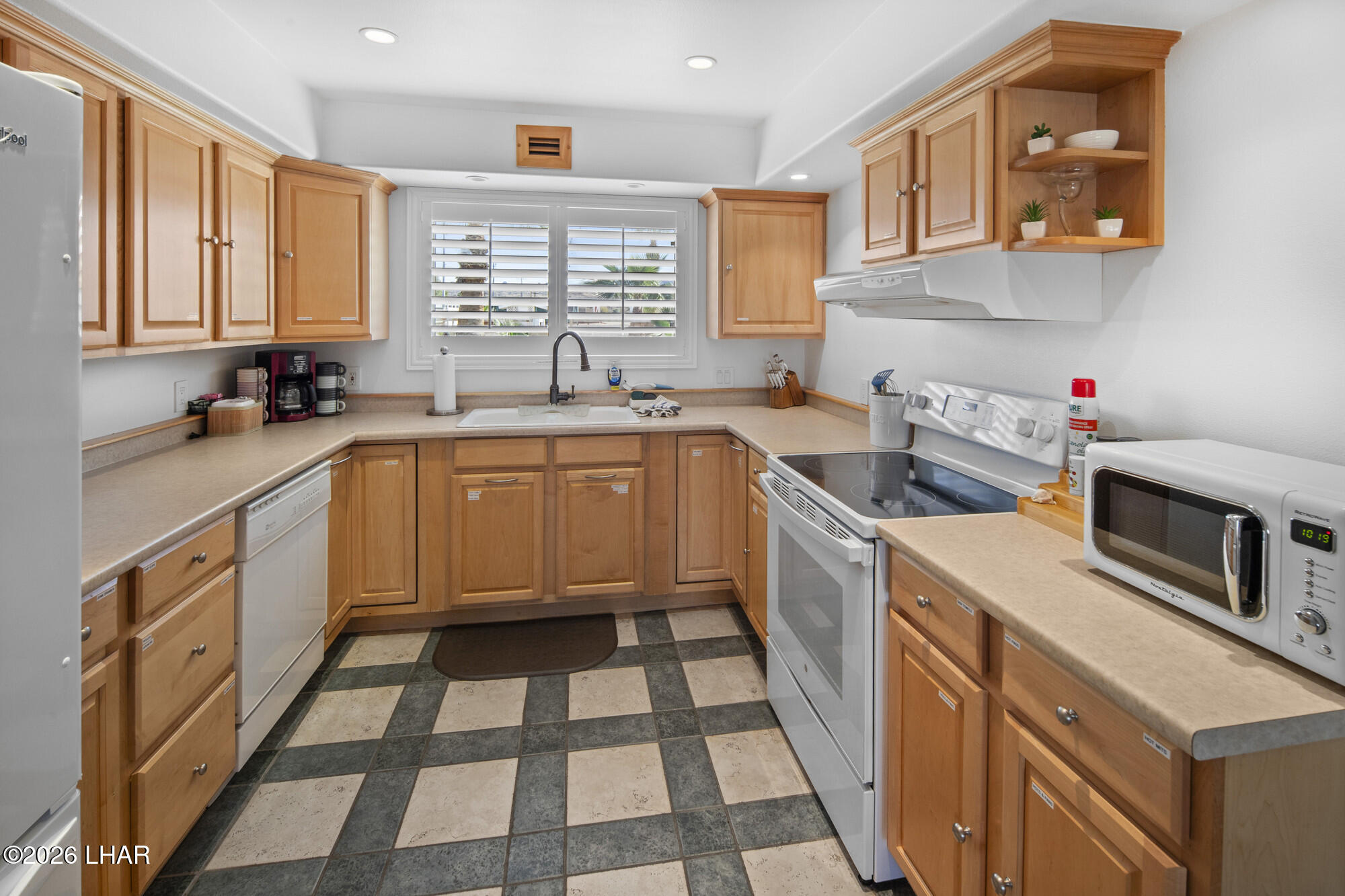 7870 Riverside Drive Parker, AZ 85344 - Photo 36 of 88 a kitchen with a sink a stove a microwave and cabinets