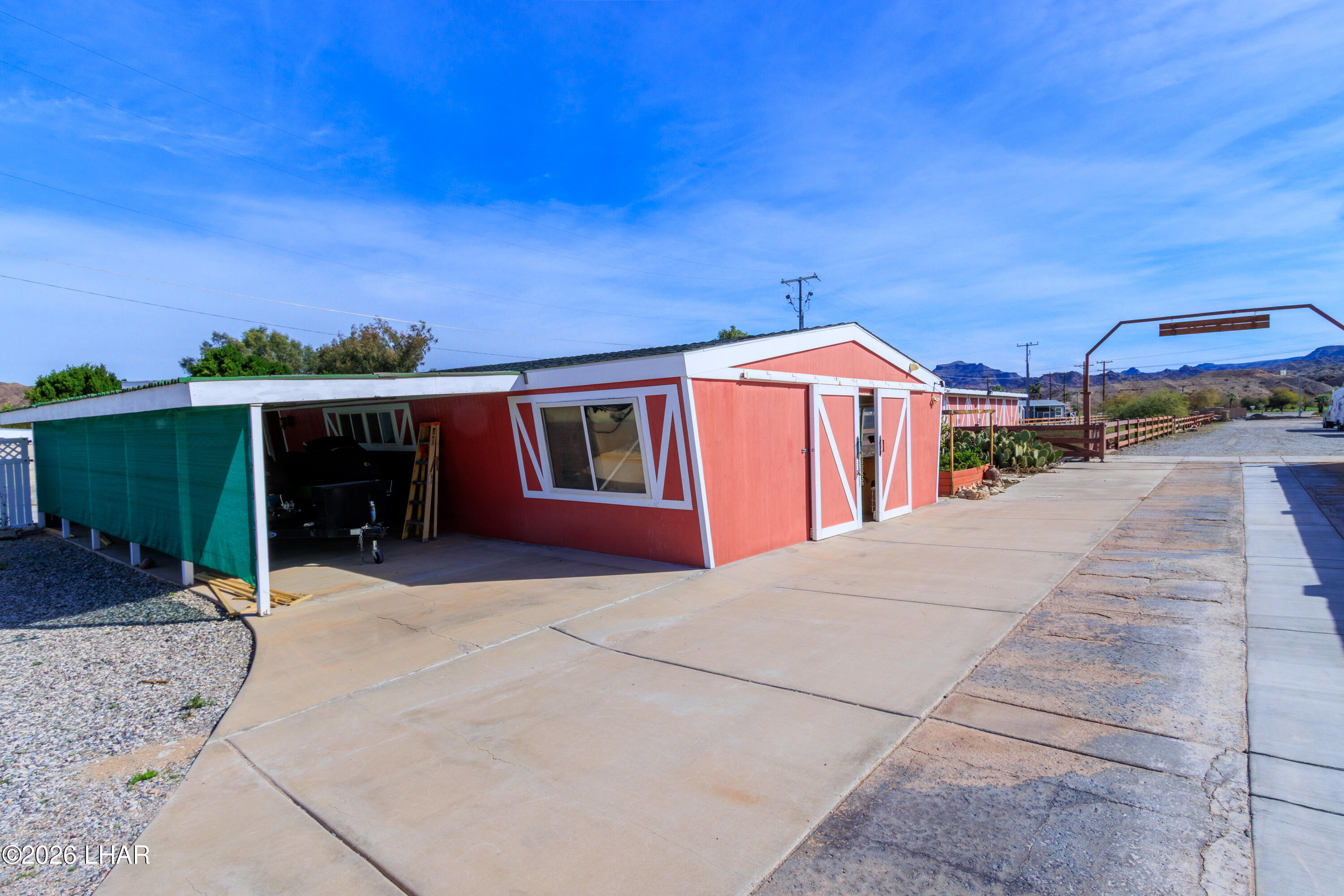 7870 Riverside Drive Parker, AZ 85344 - Photo 70 of 88 a front view of a house with a yard and garage