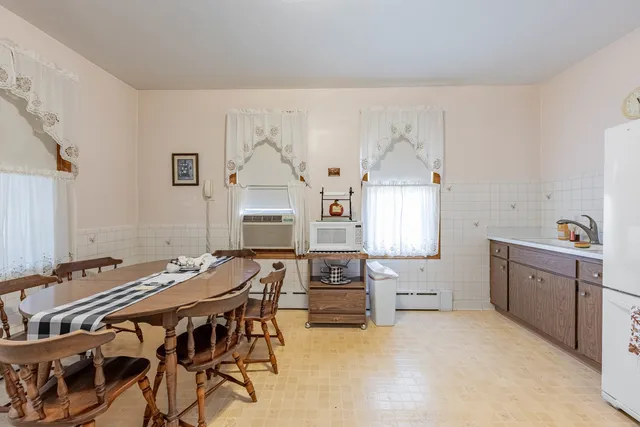 a spacious bedroom with a bed and a table in it