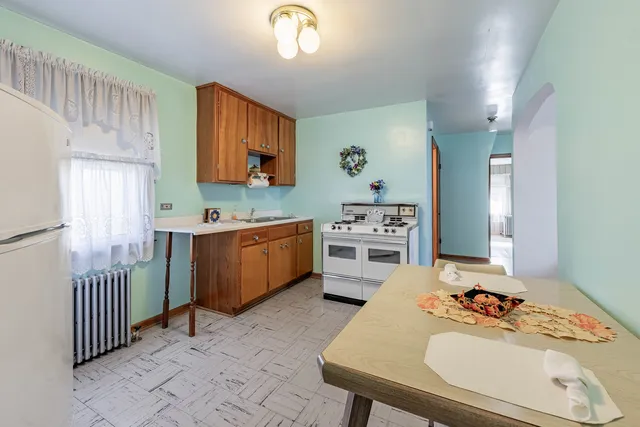 a kitchen with a sink appliances and cabinets