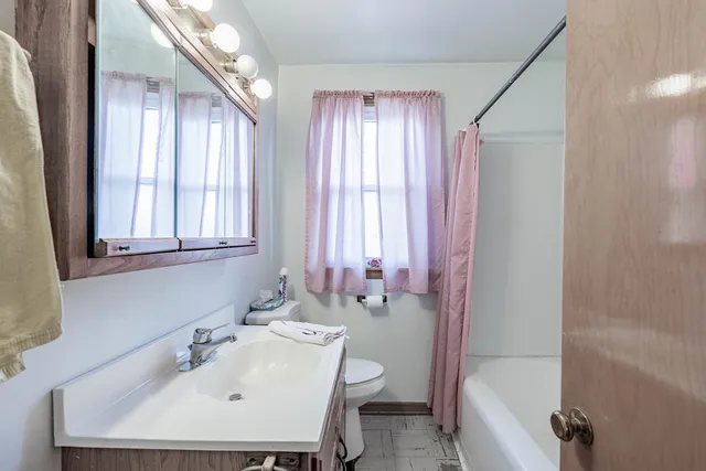 a bathroom with a sink a toilet and a bathtub