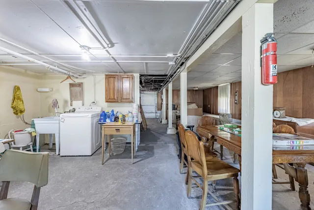 a view of a dining room with furniture and a kitchen