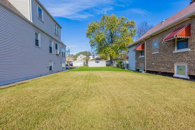 a view of a house with a yard and garage