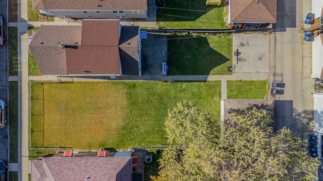 an aerial view of a house with a yard