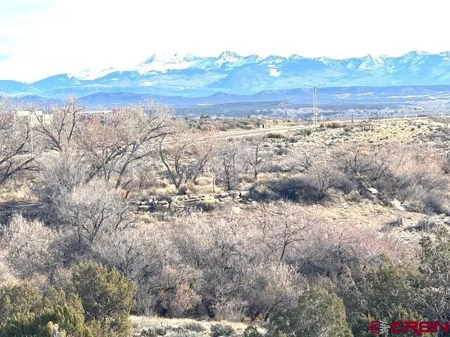 a view of a large mountain with mountains in the background