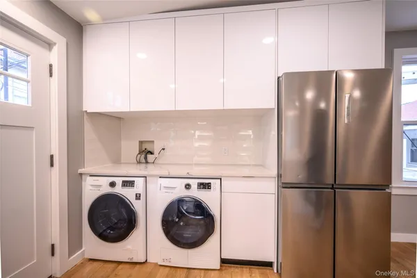 a kitchen with a refrigerator and washer