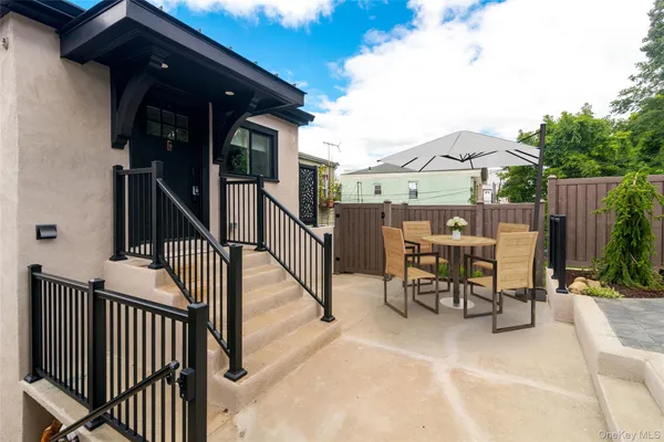 a view of a patio with a table and chairs